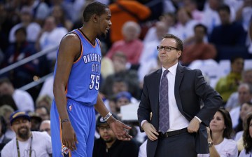 Kevin Durant talks to head coach Scott Brooks.