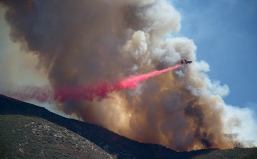 A firefighter aircraft drops fire retardant at the Cabin Fire in the Angeles National Forest on August 15, 2015 north of Azusa, California. The fire has grown to 2,500 acres with 0 percent containment under heat wave conditions. 