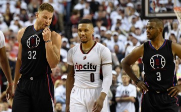 Blake Griffin has some words with Damian Lillard as Chris Paul looks on.