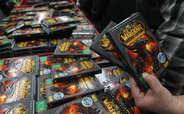 Video gaming enthusiasts scoop up the new 'World of Warcraft: Cataclysm' game shortly after midnight at the game's global sales premiere at MediaMarkt.