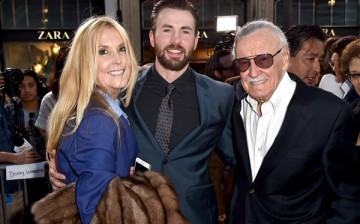 Stan Lee poses for a photo with actor Chris Evans at the premiere of 