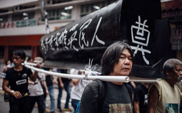 Pro-democracy activists carry a coffin to memorialize the victims of the Tiananmen Square Massacre during a rally on May 31, 2015 in Hong Kong. 