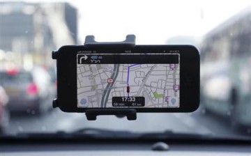 The Waze app is being used by a driver through a smartphone.