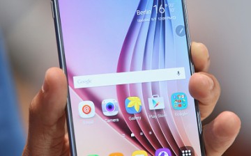 A visitor holds a Galaxy Note 5 smartphone at the Samsung stand in 2015.  