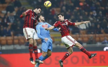 AC Milan players (in red) engaged an opponent in a play at the San Siro Stadium in Milan in Dec. 2014.