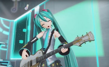 Hatsune Miku playing the guitar and singing a song.
