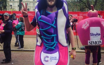 Running for a noble cause: A participant in an attention-grabbing costume makes a peace sign as he poses for the camera during the 2016 London Marathon.