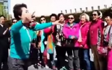 Overthrow the reactionaries: Chinese tourists perform “Socialism Is Good” in a street in New York City right outside the United Nations headquarters.