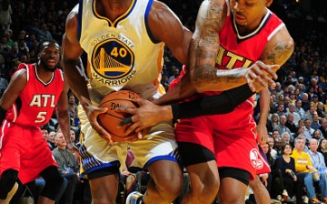 Harrison Barnes of the Golden State Warriors fights for the ball against Kent Bazemore of the Atlanta Hawks at Oracle Arena in Oakland, California.