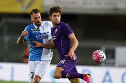 Fiorentina defender Marco Alonso (R) competes for the ball against Chievo's Fabrizio Cacciatore.