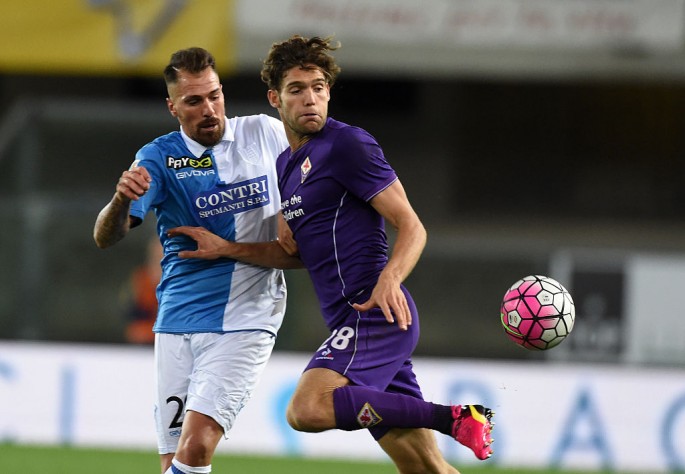 Fiorentina defender Marco Alonso (R) competes for the ball against Chievo's Fabrizio Cacciatore.