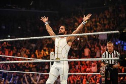 Seth Rollins is posing after he enters the ring at the WWE SummerSlam 2015.