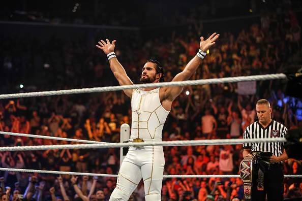 Seth Rollins is posing after he enters the ring at the WWE SummerSlam 2015.