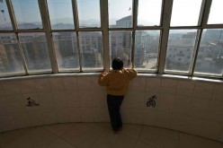  A child suffering from infantile autism looks out of the window at the Xining Orphan and Disabled Children Welfare Center on Dec. 17, 2005 in Xining of Qinghai Province, China.