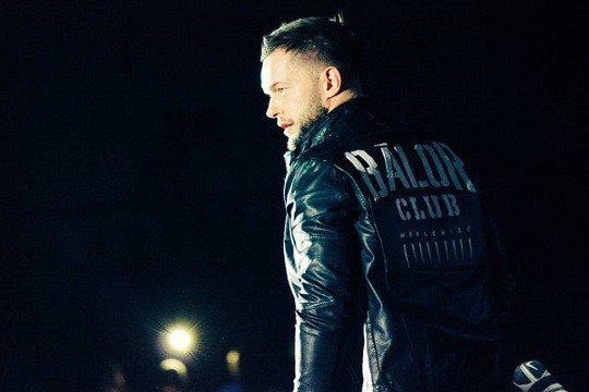 Finn Balor wearing his Balor Club jacket in an NXT event.