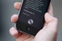 A man uses 'Siri' on the iPhone 4S after being one of the first customers in the Apple store in Covent Garden in 2011.   