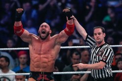 Ryback celebrates a win with a WWE referee.
