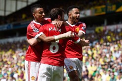 Manchester United winger Juan Mata (middle) celebrates his goal against Norwich City with teammates Jesse Lingard (L) and Memphis Depay.