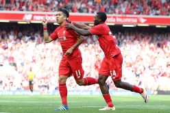 Liverpool winger Roberto Firmino (L) celebrates his goal against Watford with teammate Sheyi Ojo.