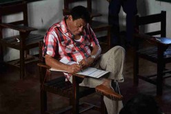 Presidential candidate Rodrigo Duterte casting his vote inside a polling precinct on May 9, 2016 in Davao city, Philippines.    
