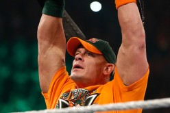 John Cena enters the ring and poses with his United States championship at WWE SummerSlam 2015.