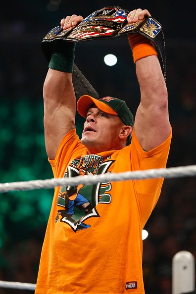 John Cena enters the ring and poses with his United States championship at WWE SummerSlam 2015.