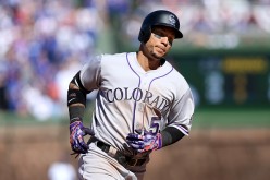 Carlos Gonzalez of the Colorado Rockies is rounding the bases after hitting a home run.