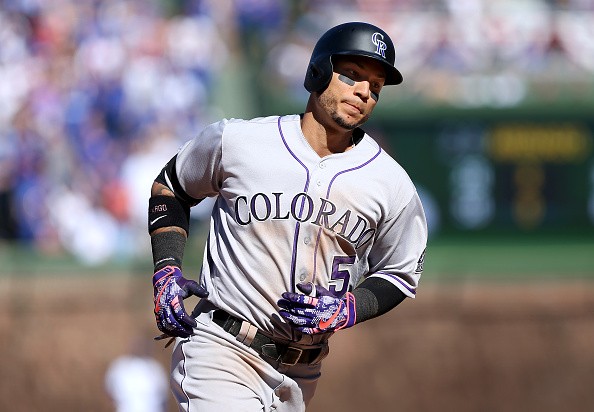 Carlos Gonzalez of the Colorado Rockies is rounding the bases after hitting a home run.