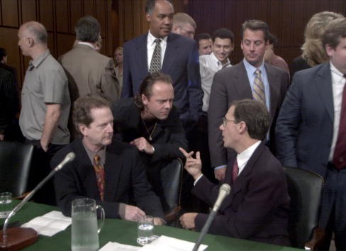 Roger McGuinn, a member of The Byrds, seated left, Lars Ulrich of Metallica center, Hank Barry CEO Napster seated right, share words before the Senate Judiciary Committee July 11, 2000, in Washington, DC where they testified on musical copyright and the I