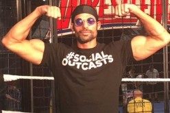 WWE Superstar Adam Rose poses with his Social Outcast shirt.
