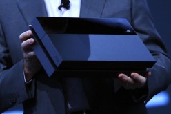 Andrew House, President and Group CEO Sony Computer Entertainment Inc., holds up a Playstation 4, not the PlayStation NEO 
