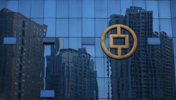 Buildings under construction are reflected on glass at the People's Bank of China office building on Sept. 29, 2007 in Chongqing, China.