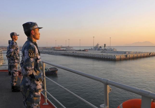 Chinese soldiers stand guard in a naval base across Sanya in Hainan Province.