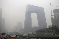  Vehicles move on the street early morning in heavy smog in front of the CCTV headquarters on Nov. 12, 2015 in Beijing, China. 