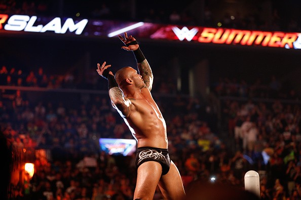 Randy Orton is inside the ring and posing in front of a live crowd.