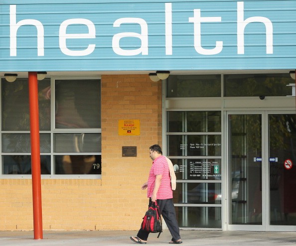 A man walks past a Community Health Centre on May 13, 2014 in Melbourne, Australia.