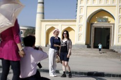 Tourists posing in front of the Golden Palace at the World Muslim City theme park in Yinchuan.