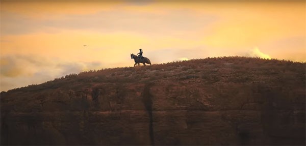 "Red Dead Redemption's" protagonist John Marston travelling through the Wild West with his horse.