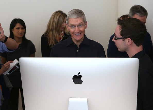 Apple CEO Tim Cook looks at the new 27 inch iMac with 5K retina display during an Apple special event