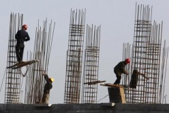 Construction workers lay the foundation for a new apartment building in Henan Province.