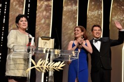Jaclyn Jose reacts on stage as Andi Eigenmann and director Brillante Mendoza applaud after being awarded the Best Actress prize during the closing ceremony of the annual 69th Cannes Film Festival. 