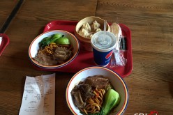 Photo taken on May 20, 2016 shows two bowls of noodles, one cup of coke and one basket of pork buns which cost 180 yuan ($28) at the Shanghai Disney Resort. 