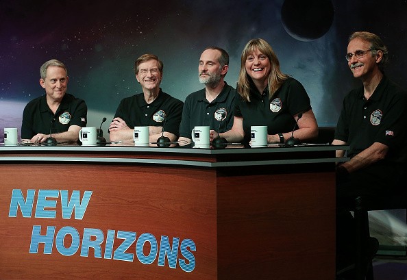 (L-R) Principal investigator Alan Stern, project scientist Hal Weaver, investigator Will Grundy, project scientist Cathy Olkin and imaging team leader John Spencer celebrate after seeing images from the New Horizons spacecraft that passed with 7,800 miles