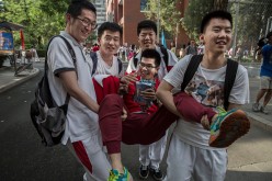 Chinese students joke with each other as they carry one student after completing the gaokao at the Beijing Renmin University Affiliated High School on June 8, 2015 in Beijing, China.