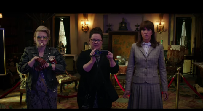 The characters of Kate McKinnon, Melissa McCarthy and Kristen Wiig encounter a ghost in a scene of the "Ghostbusters" movie. 