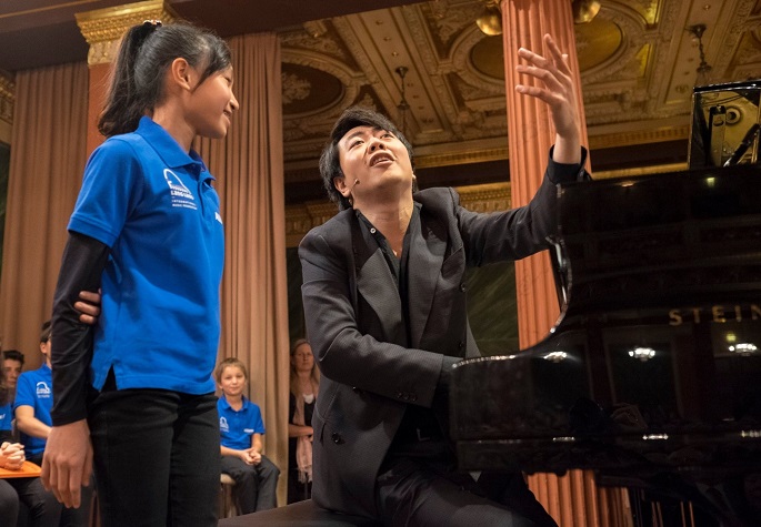 Passionate player, passionate teacher: A student smiles as Lang Lang animatedly shares pointers.