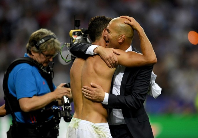 Real Madrid manager Zinedine Zidane (R) hugs star man Cristiano Ronaldo after Champions League win over Atletico Madrid.