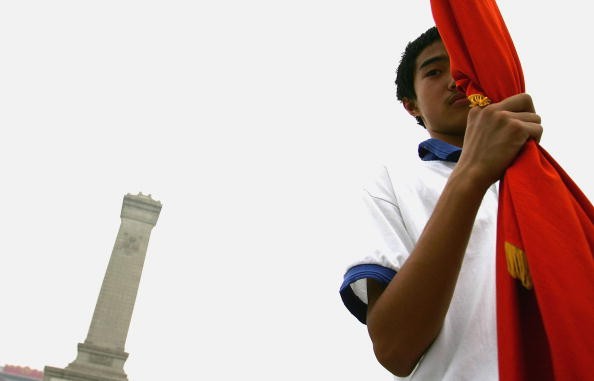 A Chinese Young Pioneer at Tiananmen Square on May 31, 2005. The Young Pioneer, a teenager organization, is guided by the Communist Youth League over the past five decades.
