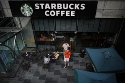 Customers leave a Starbucks retail store in Shanghai.
