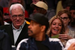 Phil Jackson, president of the New York Knicks, sits with Jeanie Buss, part-owner and president the Los Angeles Lakers, at Staples Center on March 12, 2015 in Los Angeles, California.